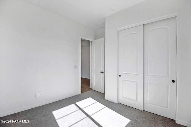 unfurnished bedroom with carpet floors and a closet