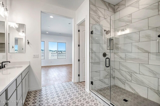 bathroom with a shower with door, vanity, and hardwood / wood-style floors