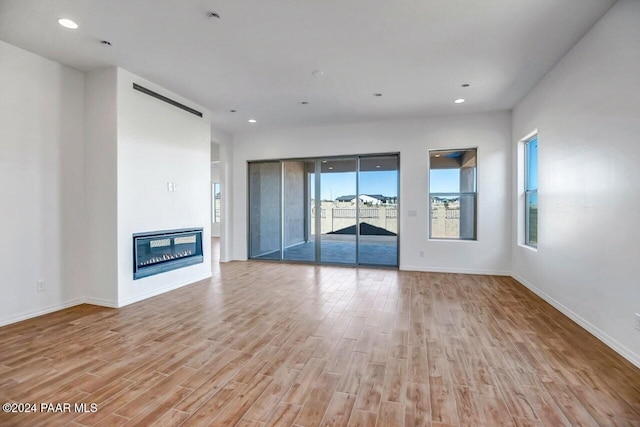 unfurnished living room with light wood-type flooring