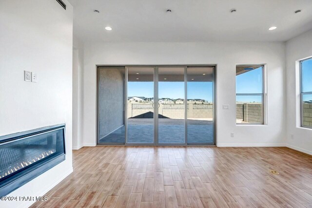 unfurnished living room featuring light hardwood / wood-style flooring