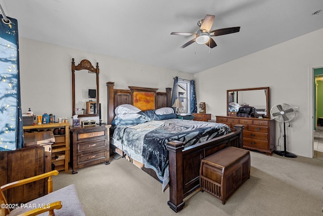 bedroom featuring light carpet, lofted ceiling, and ceiling fan