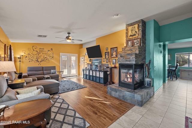 living room with light tile patterned floors and ceiling fan