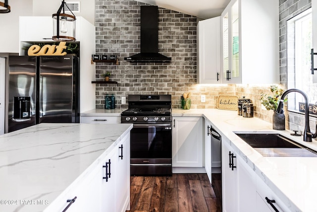 kitchen with white cabinetry, sink, wall chimney range hood, dark hardwood / wood-style flooring, and black appliances