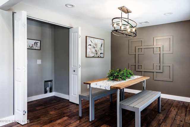 dining room featuring a notable chandelier and dark wood-type flooring