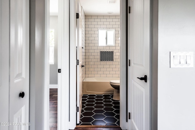 bathroom featuring hardwood / wood-style floors and toilet