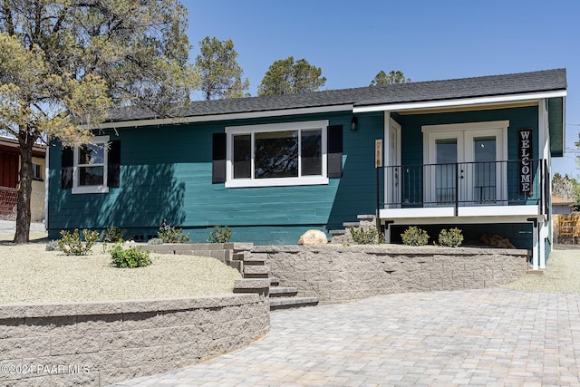 single story home with french doors and a porch