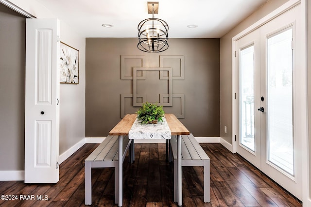 dining room featuring a chandelier, dark wood-type flooring, and french doors