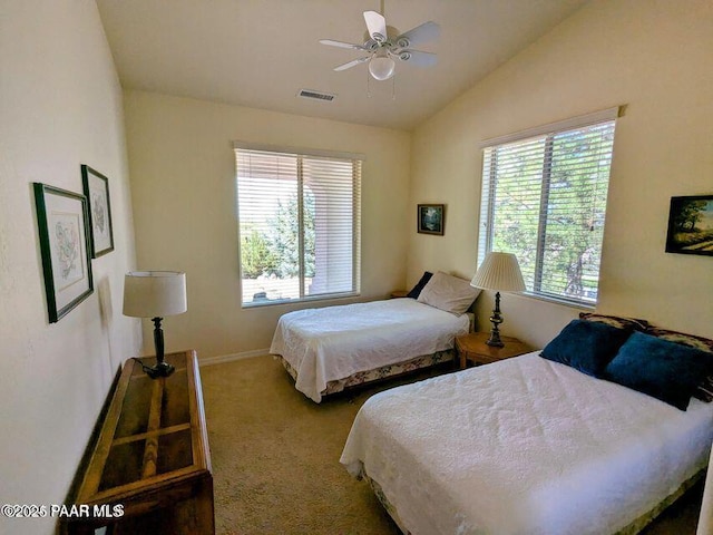 carpeted bedroom with lofted ceiling, baseboards, visible vents, and a ceiling fan