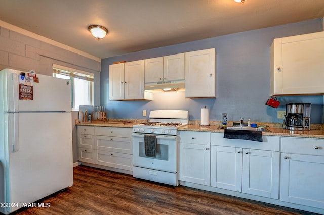 kitchen with light stone countertops, white appliances, white cabinetry, and dark wood-type flooring