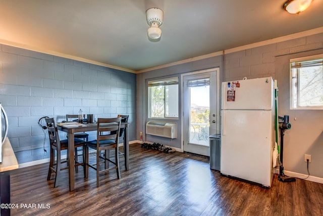 dining area with a wall unit AC and dark wood-type flooring