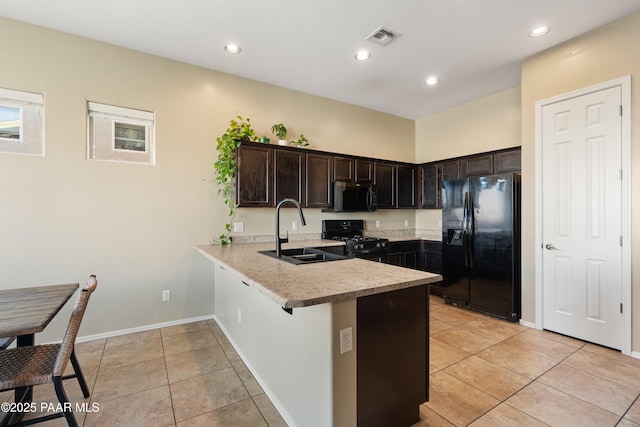 kitchen with dark brown cabinetry, sink, light tile patterned floors, kitchen peninsula, and black appliances