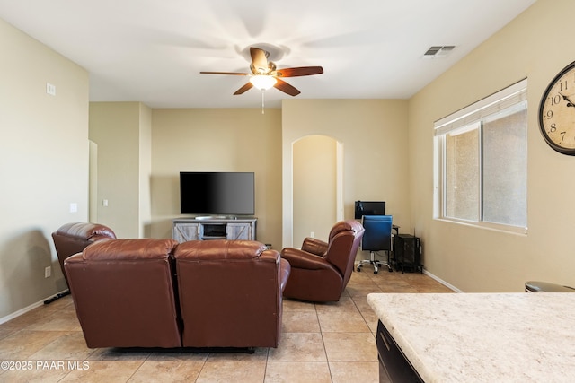 tiled living room featuring ceiling fan