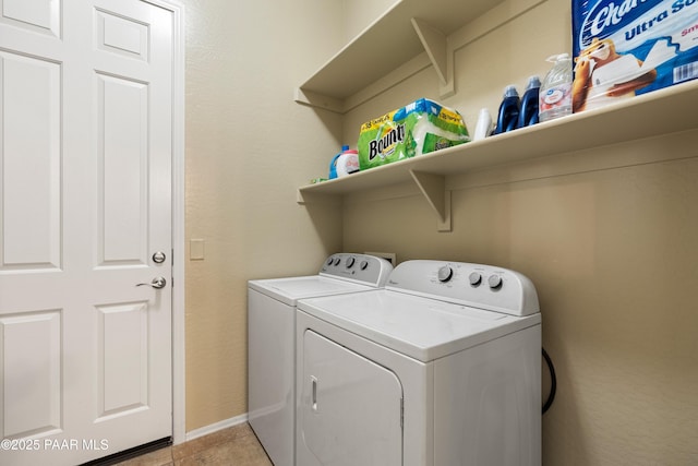 laundry area with light tile patterned flooring and washer and dryer