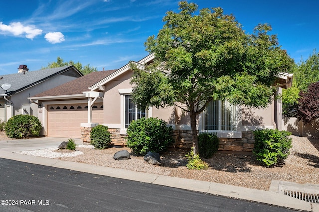 obstructed view of property with a garage