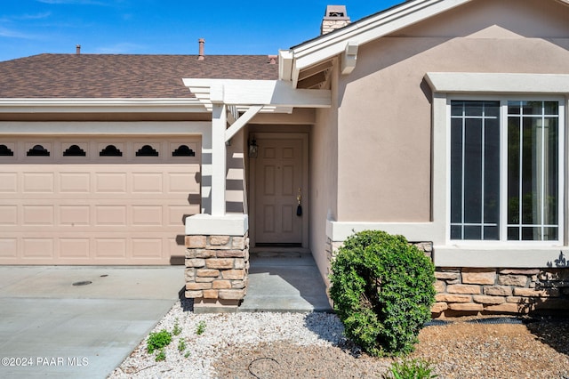 doorway to property featuring a garage