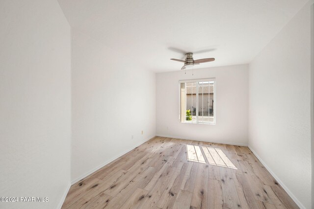 unfurnished room with light wood-type flooring and ceiling fan