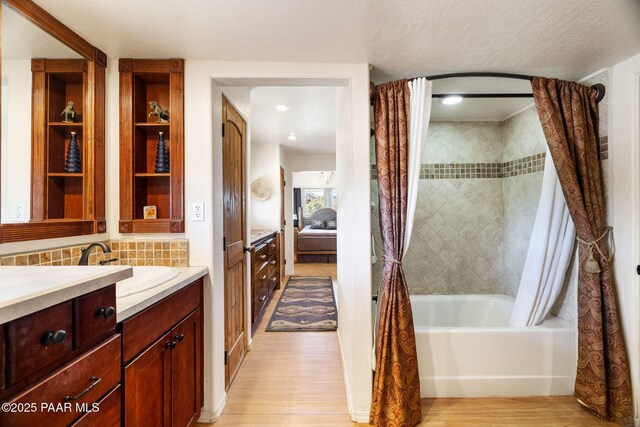 6850 N Harris Dr, Prescott, AZ 86305 - ensuite bathroom featuring wood finished floors, vanity, and shower / tub combo with curtain