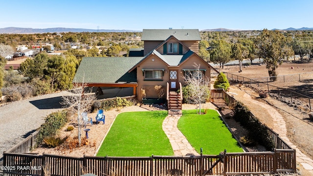 view of front of house featuring a mountain view and a front yard