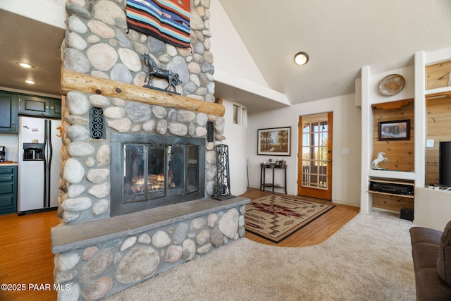 living room featuring a stone fireplace, carpet floors, and lofted ceiling