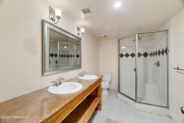 bathroom with walk in shower, vanity, toilet, and tile patterned flooring