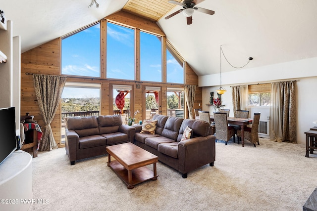 living room with light colored carpet, high vaulted ceiling, and a wealth of natural light