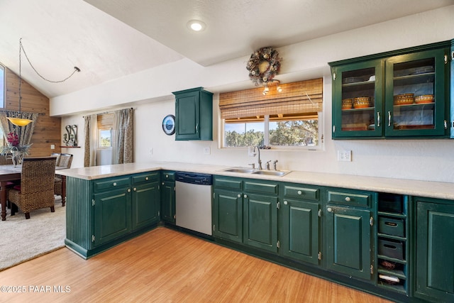 kitchen with stainless steel dishwasher, kitchen peninsula, sink, and light hardwood / wood-style flooring