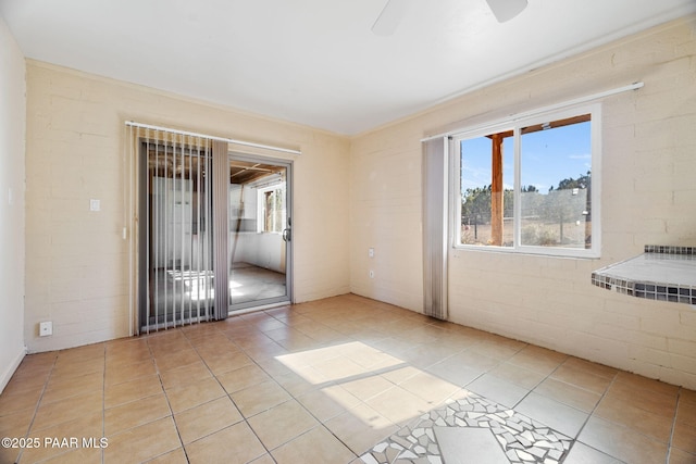 tiled spare room with brick wall