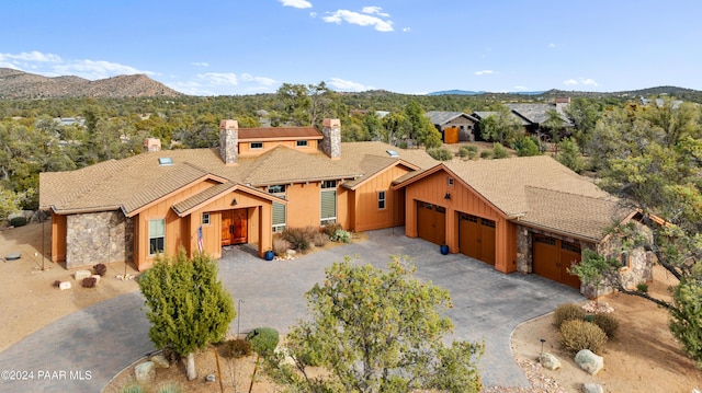 view of front of property with a mountain view and a garage