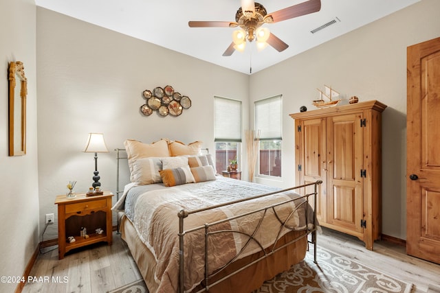 bedroom with ceiling fan and light hardwood / wood-style floors