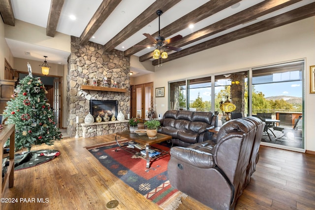 living room featuring a fireplace, dark hardwood / wood-style floors, ceiling fan, and beamed ceiling