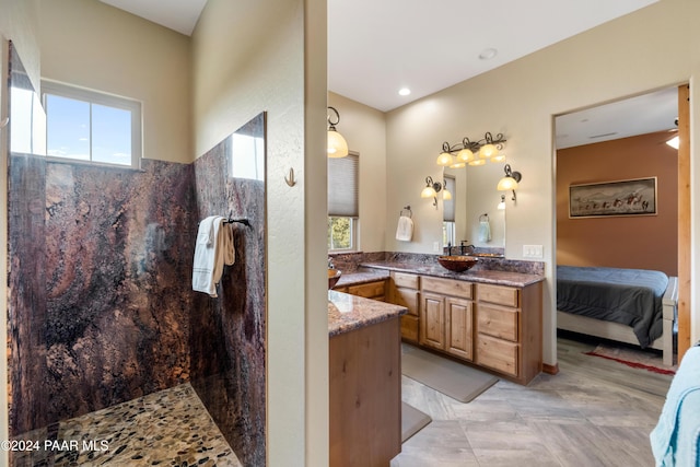 bathroom with vanity and tiled shower