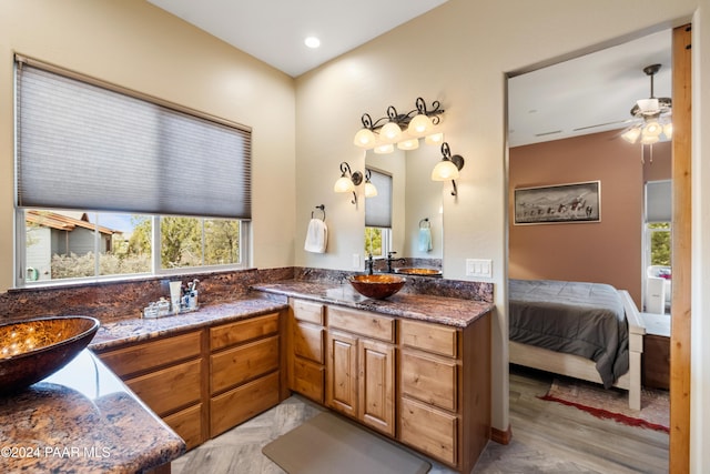 bathroom featuring ceiling fan, hardwood / wood-style floors, and vanity