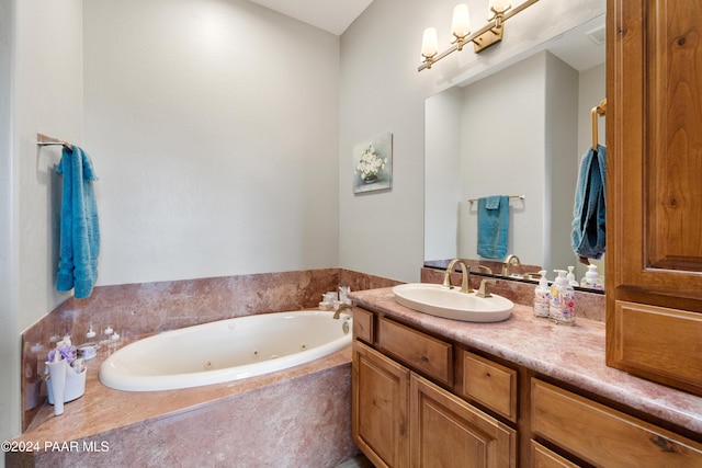 bathroom featuring vanity and tiled tub