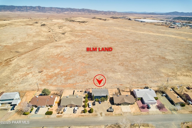 birds eye view of property with a mountain view