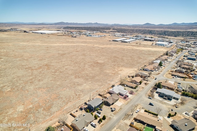 drone / aerial view featuring view of desert and a mountain view