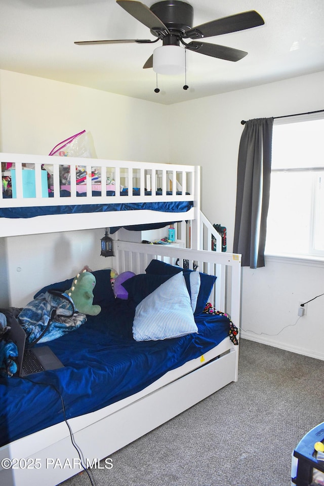 bedroom with baseboards, carpet, and a ceiling fan