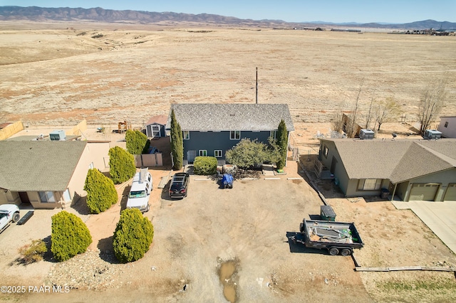 drone / aerial view featuring view of desert and a mountain view