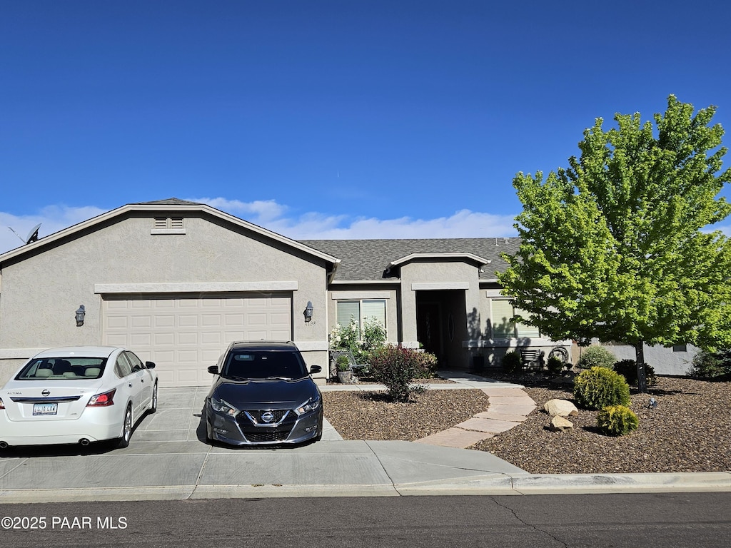 4198 N Pembroke St, Prescott Valley, AZ 86314 - ranch-style house with a garage, concrete driveway, stucco siding, and a shingled roof