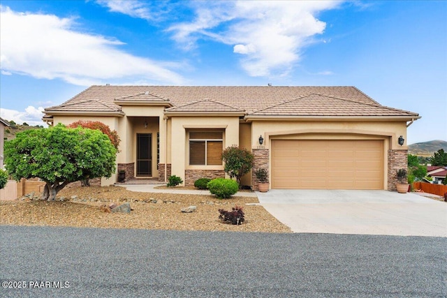 1395 N Rustlers Roost, Dewey-Humboldt, AZ 86327 - prairie-style home featuring stone siding, driveway, stucco siding, and an attached garage