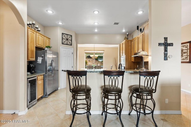 1395 N Rustlers Roost, Dewey-Humboldt, AZ 86327 - kitchen featuring beverage cooler, stainless steel refrigerator with ice dispenser, a peninsula, a breakfast bar, and recessed lighting