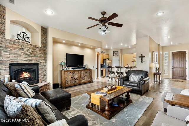 1395 N Rustlers Roost, Dewey-Humboldt, AZ 86327 - living area with ceiling fan, light wood-type flooring, a stone fireplace, and recessed lighting