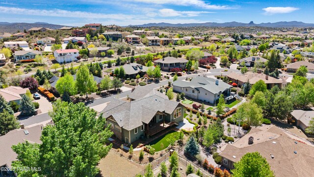 drone / aerial view featuring a residential view and a mountain view