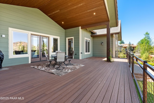 wooden terrace with french doors and outdoor dining area