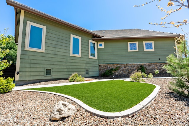 rear view of property with a lawn