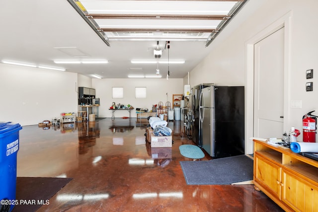 garage featuring a garage door opener and freestanding refrigerator