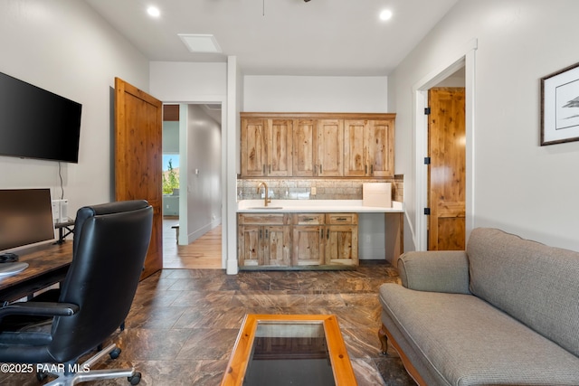 office space featuring recessed lighting, a sink, and stone finish flooring