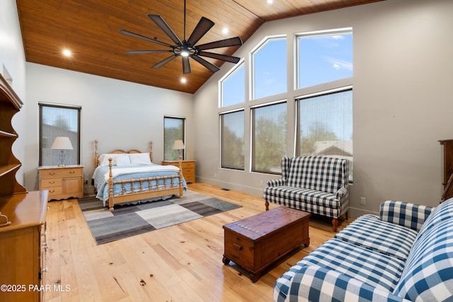 bedroom with high vaulted ceiling, wooden ceiling, baseboards, and light wood finished floors