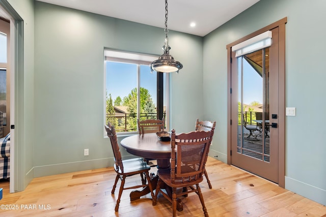 dining space featuring recessed lighting, baseboards, light wood finished floors, and a wealth of natural light