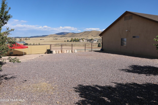 view of yard featuring a mountain view and a rural view