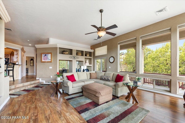 living room with hardwood / wood-style flooring, ceiling fan, and a wealth of natural light